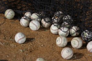 baseballs next to net after pitching lessons for off season